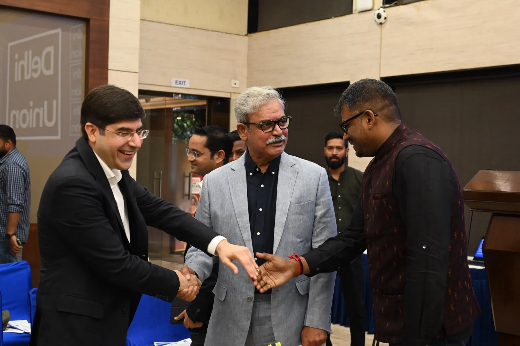 Speakers and members meet on the floor after the sitting